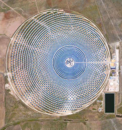 This Overview captures the Gemasolar Thermosolar plant in Seville, Spain. The solar concentrator contains 2,650 heliostat mirrors that focus the sun’s thermal energy to heat molten salt flowing through a 140-metre (460-foot) central tower. The molten salt then circulates from the tower to a storage tank, where it is used to produce steam and generate electricity. In total, the facility displaces approximately 30,000 tonnes of carbon dioxide emissions every year.