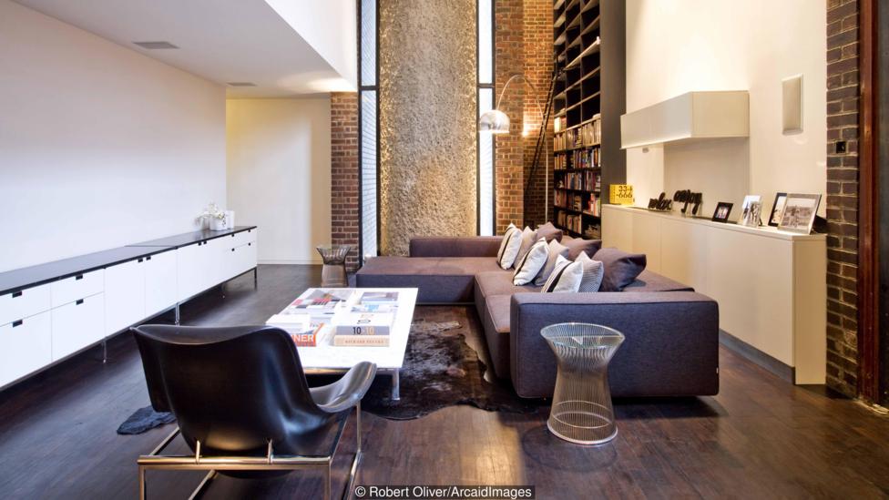 Open plan double height living room in Barbican Apartment, London, UK.
